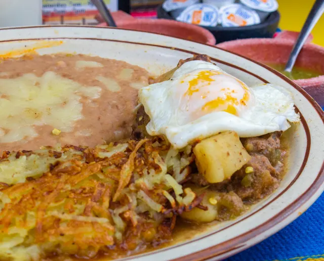 Fried egg over hash browns with refried beans